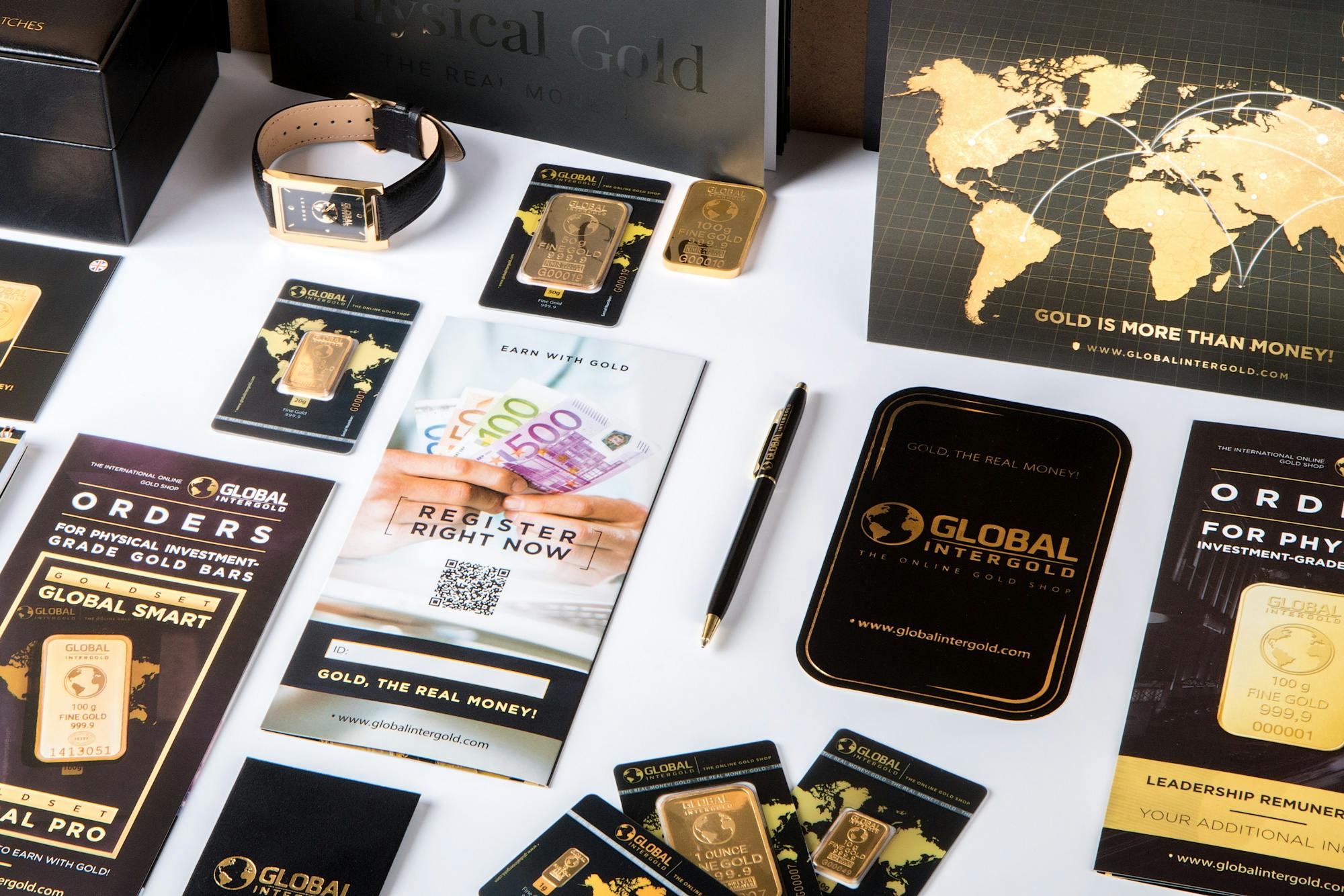 Home Flat lay of promotional materials for gold investment, featuring brochures, cards, and gold bars.