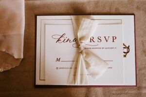 An elegant wedding RSVP invitation card with a tied bow, perfect for a special occasion.