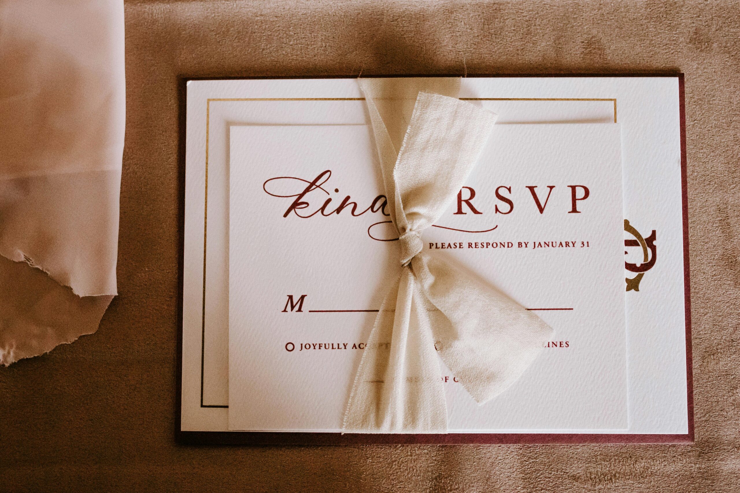 Home An elegant wedding RSVP invitation card with a tied bow, perfect for a special occasion.